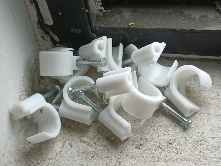 Real photograph of plastic cable clips used for cable organisation, illustrative example